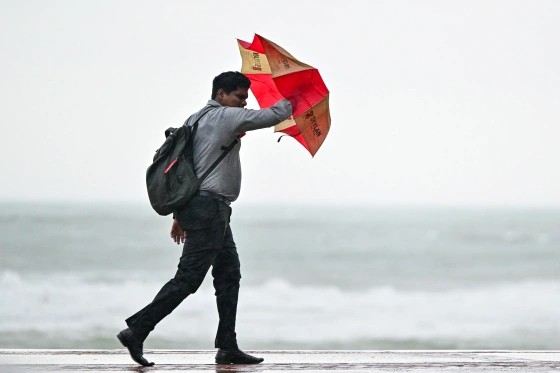 A man carries an umbrella amid rainfall in Colombo on Thursday.Ishara S. Kodikara.jpeg