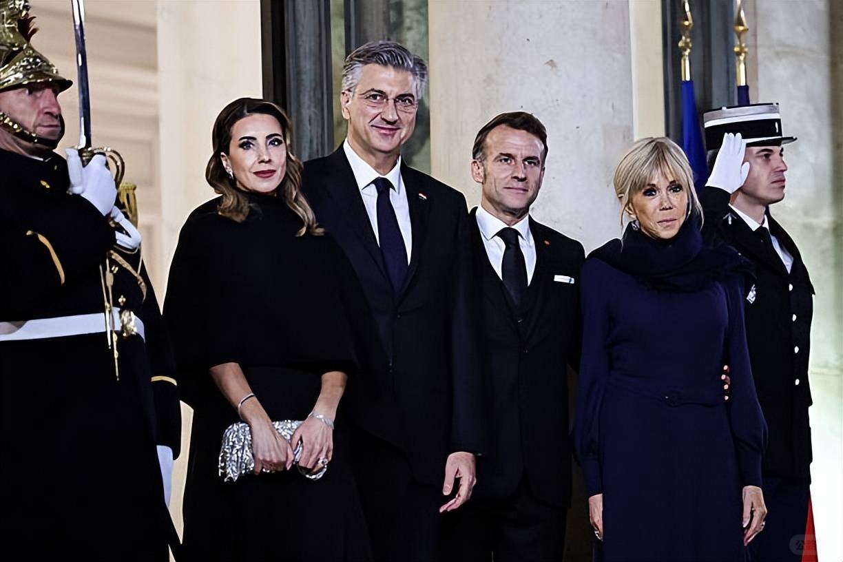 Brigitte welcomes the Croatian Prime Minister and his wife! Wearing a blue dress.jpeg