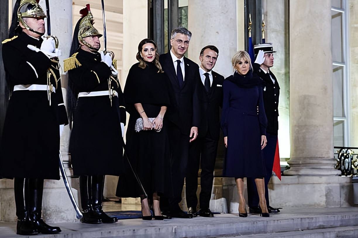 Brigitte welcomes the Croatian Prime Minister and his wife! Wearing a blue dress.jpeg
