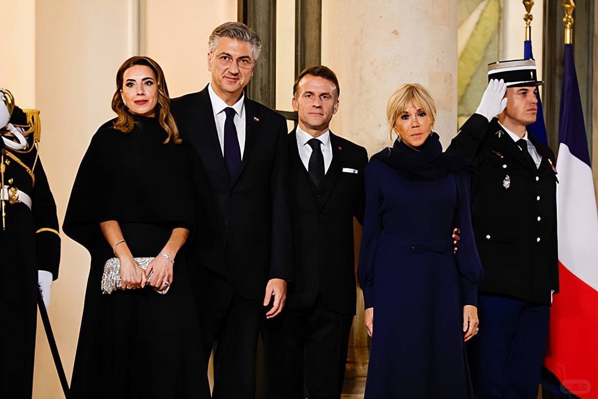 Brigitte welcomes the Croatian Prime Minister and his wife! Wearing a blue dress.jpeg