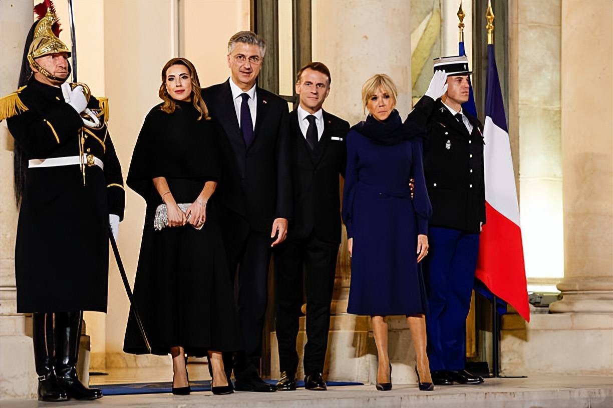 Brigitte welcomes the Croatian Prime Minister and his wife! Wearing a blue dress.jpeg