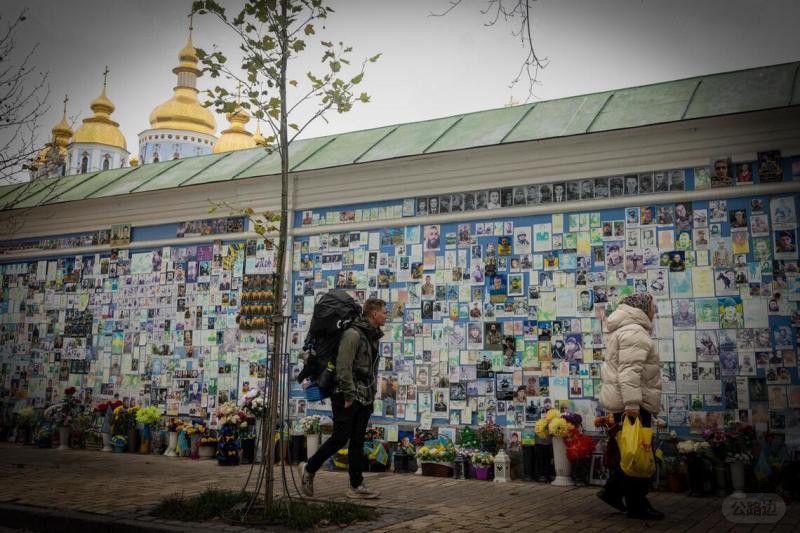 On December 9th, pedestrians walked past the Ukrainian War Memorial Wall located.jpg